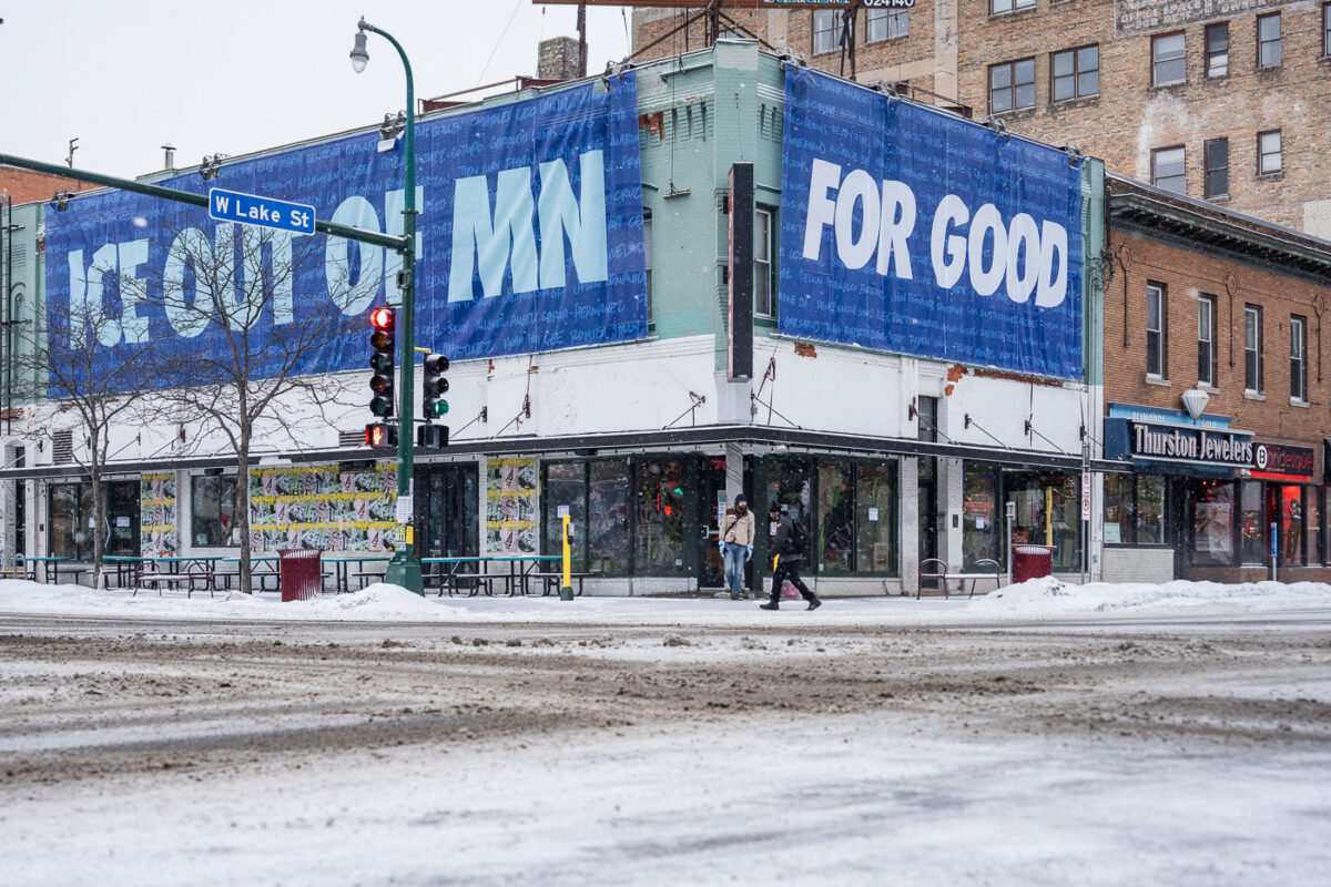 Large banner hangs over a building at Lake Street and Lyndale Avenue on a snowy morning.
It reads "ICE OUT OF MN" "FOR GOOD" with the names of those killed by federal agents.