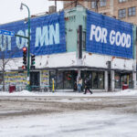 ICE OUT OF MN FOR GOOD Lyndale and Lake Banner 4 Large banner hangs over a building at Lake Street and Lyndale Avenue on a snowy morning. It reads "ICE OUT OF MN" "FOR GOOD" with the names of those killed by federal agents.