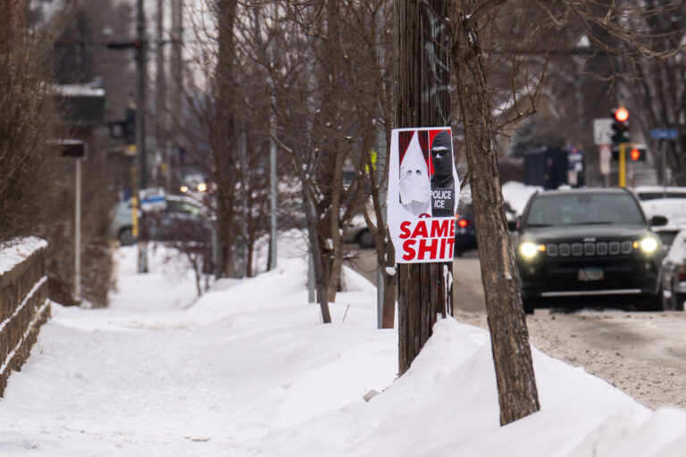 Minneapolis Poster: KKK and ICE Comparison 2 A poster comparing ICE to the KKK is displayed on a utility pole in snowy South Minneapolis.