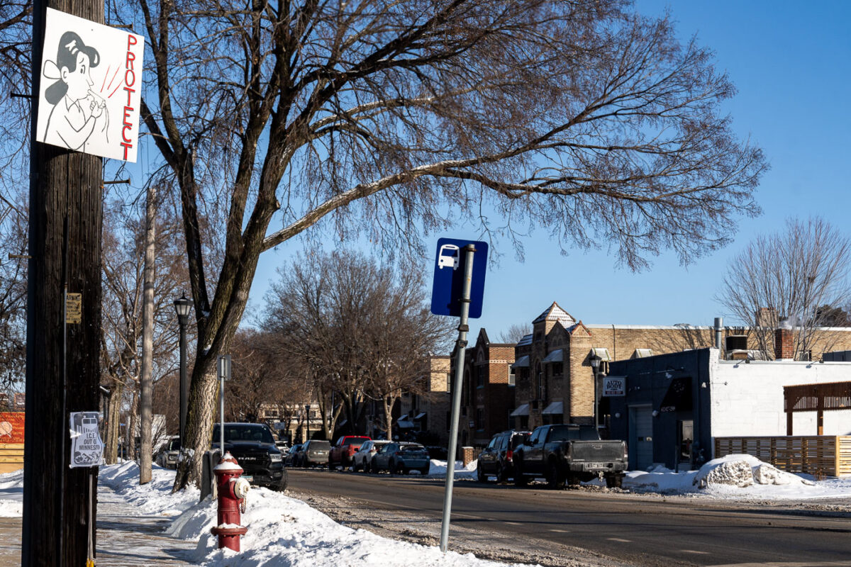 A "Protect" sign showing a cartoon woman with a whistle. Whistles are used to warn those in the area that ICE is nearby.