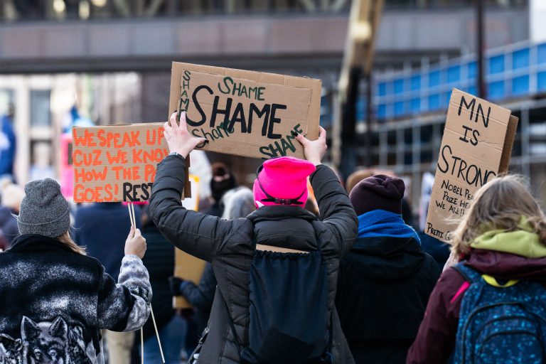 Minneapolis Anti-ICE Protest: "Shame" Signs 1 Protesters hold "Shame" signs at an anti-ICE rally in downtown Minneapolis.