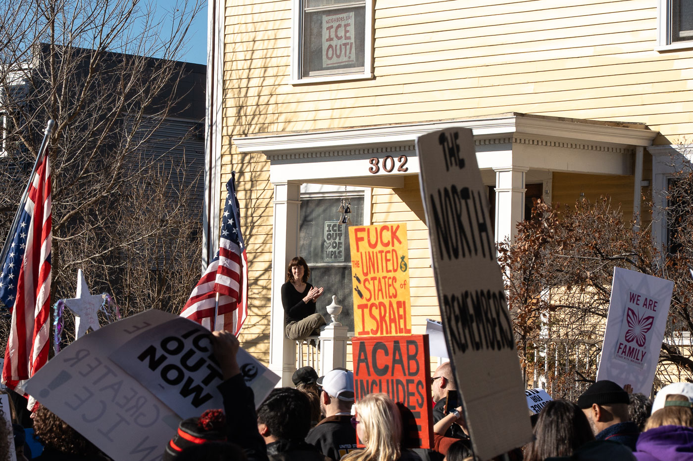 Woman watches protesters pass by in Minneapolis