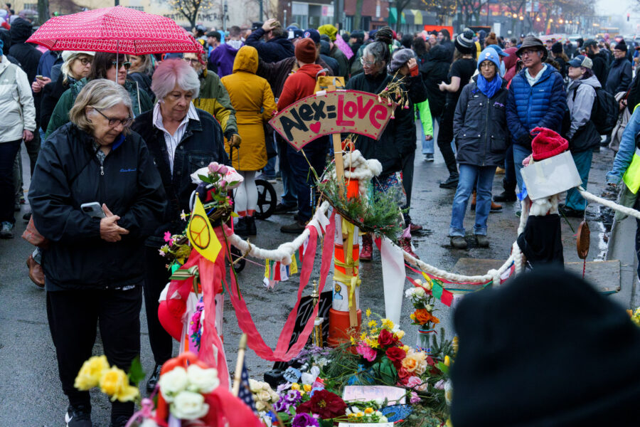 Alex Pretti Memorial Gathering with Flowers and Signs