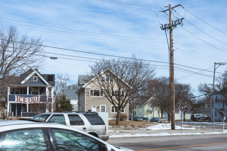 Minneapolis "ICE OUT" Banner on Residential Street 2 A banner reading "ICE OUT" is displayed on a residential street in Minneapolis, a slogan protesting U.S. Immigration and Customs Enforcement.