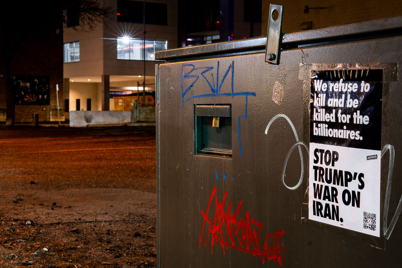 Anti-war protest flyer on a utility box in Uptown Minneapolis reads "STOP TRUMP'S WAR ON IRAN." Early 2020.