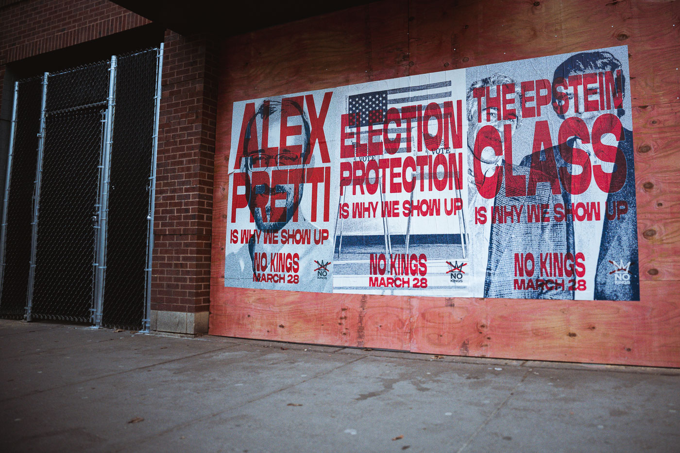 Protest posters in Uptown Minneapolis advocate for Alex Pretti, election protection, and "No Kings" on March 28, displayed on a plywood-covered wall.