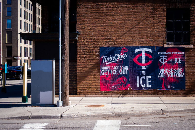 Minneapolis Protest Posters: Pohlad Family Whose Side Are You On? 1 Minneapolis protest posters on a brick building critique the Pohlad family's ownership of the Minnesota Twins and alleged ties to ICE.