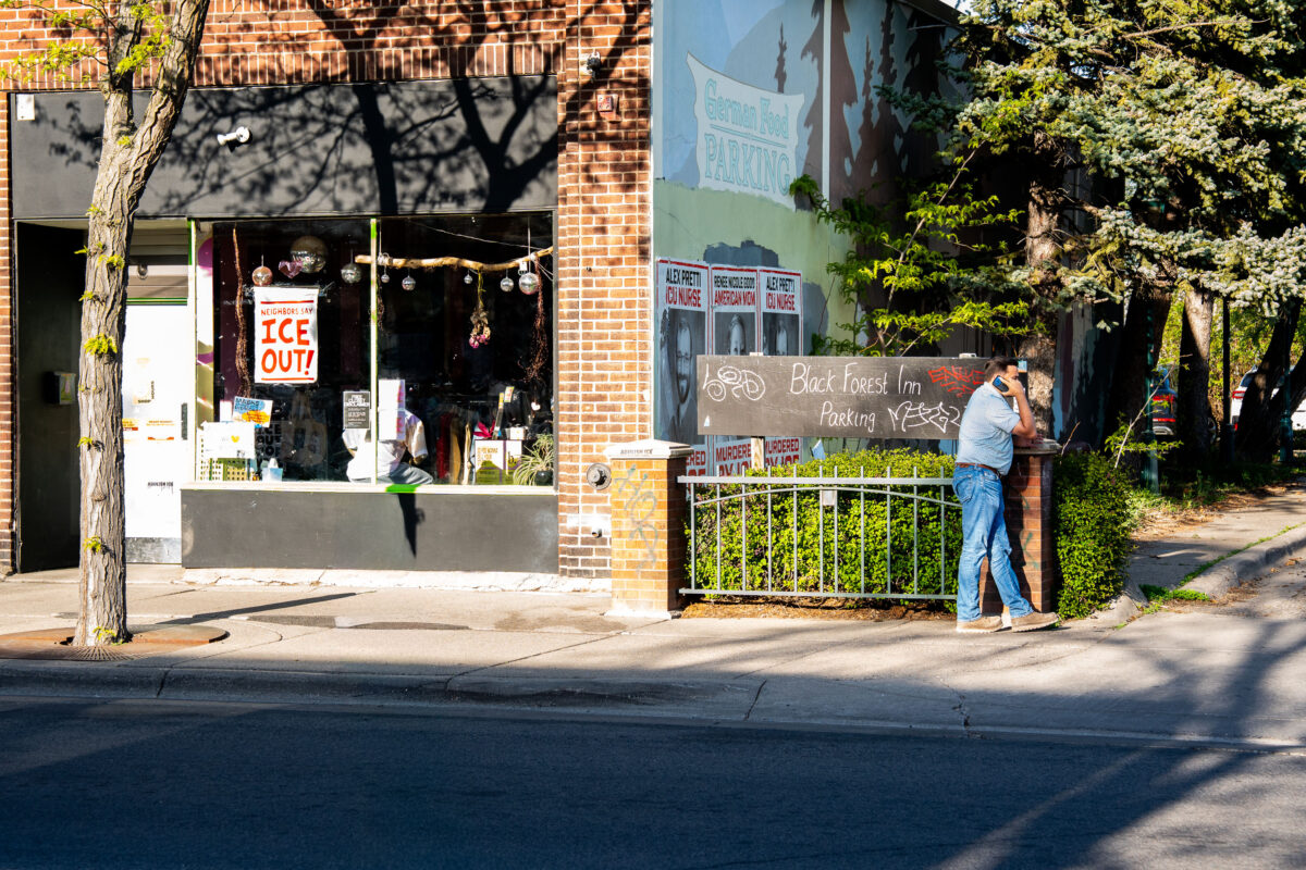 Man on cell phone across from Alex Pretti Memorial