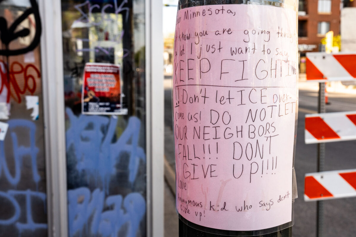 Kids leaves protest sign at Alex Pretti Memorial