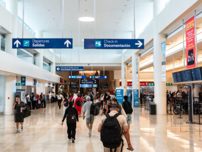Passengers in Cancun International Airport Departures Hall
