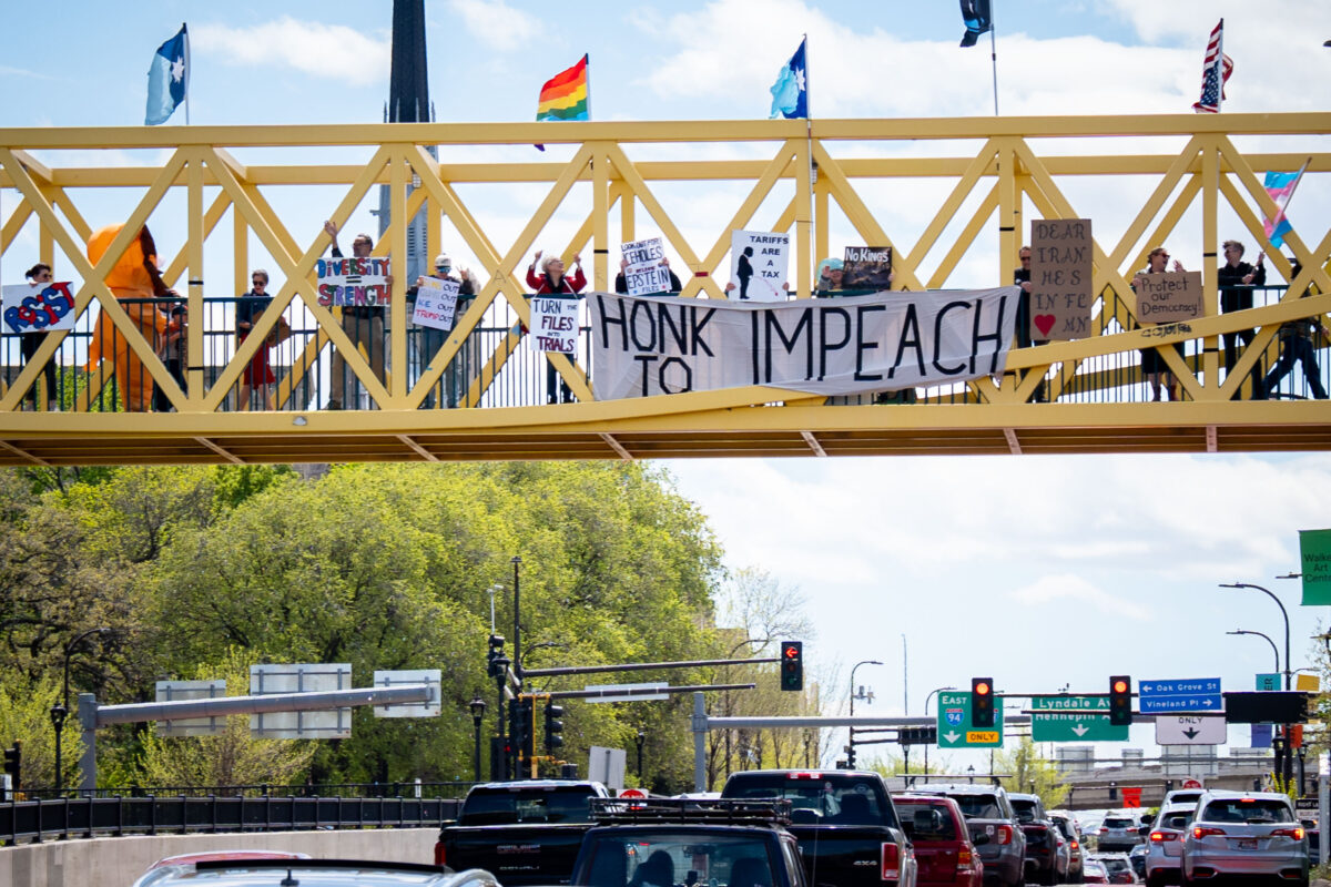 Protesters hold HONK TO IMPEACH sign in Minneapolis