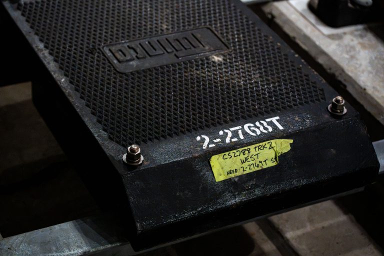 Rail Tie Plate Marked 2-2768T, Southwest LRT, Minneapolis 4 Close-up of a black speaker or audio equipment component labeled "2-2T68T" with a yellow identification sticker.