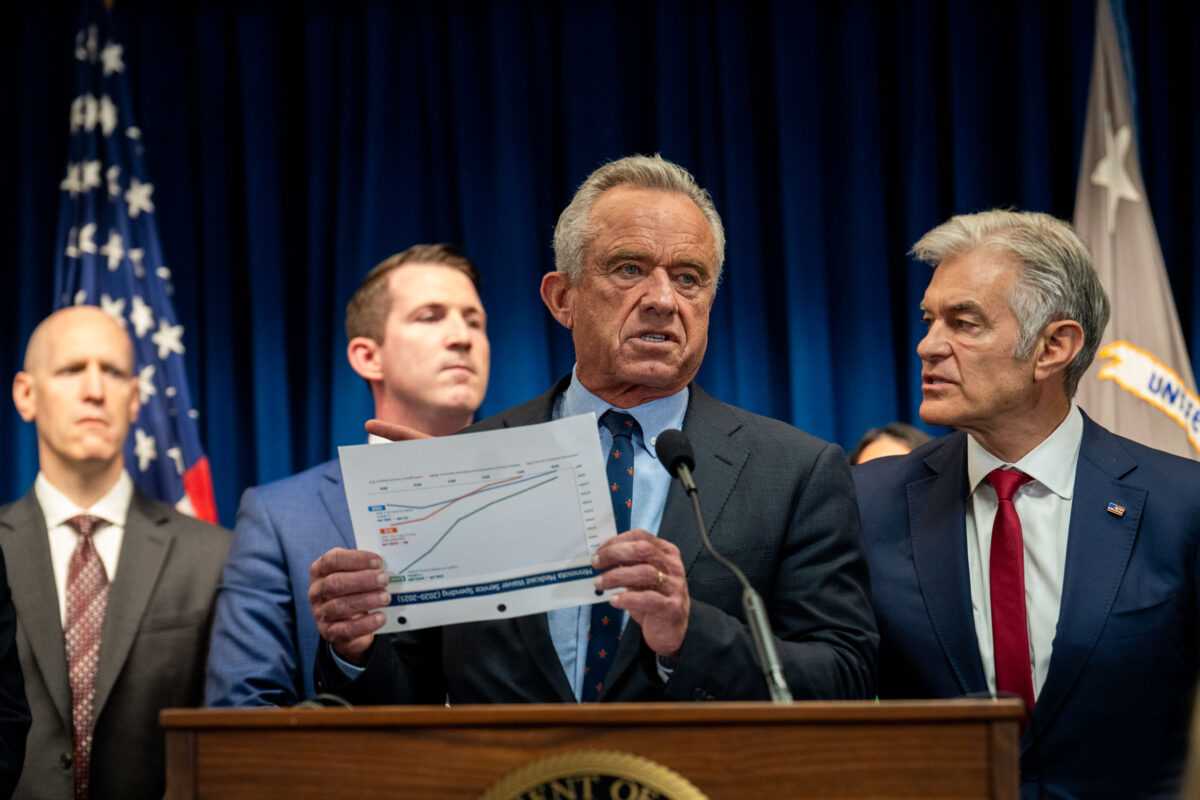 Robert F Kennedy Jr. holds up a chart at Minneapolis News Conference