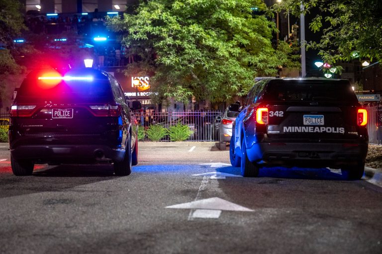 Minneapolis Police and KISS Nightclub, Minneapolis 3 Marked and unmarked squad cars idle outside Uptown nightclubs
