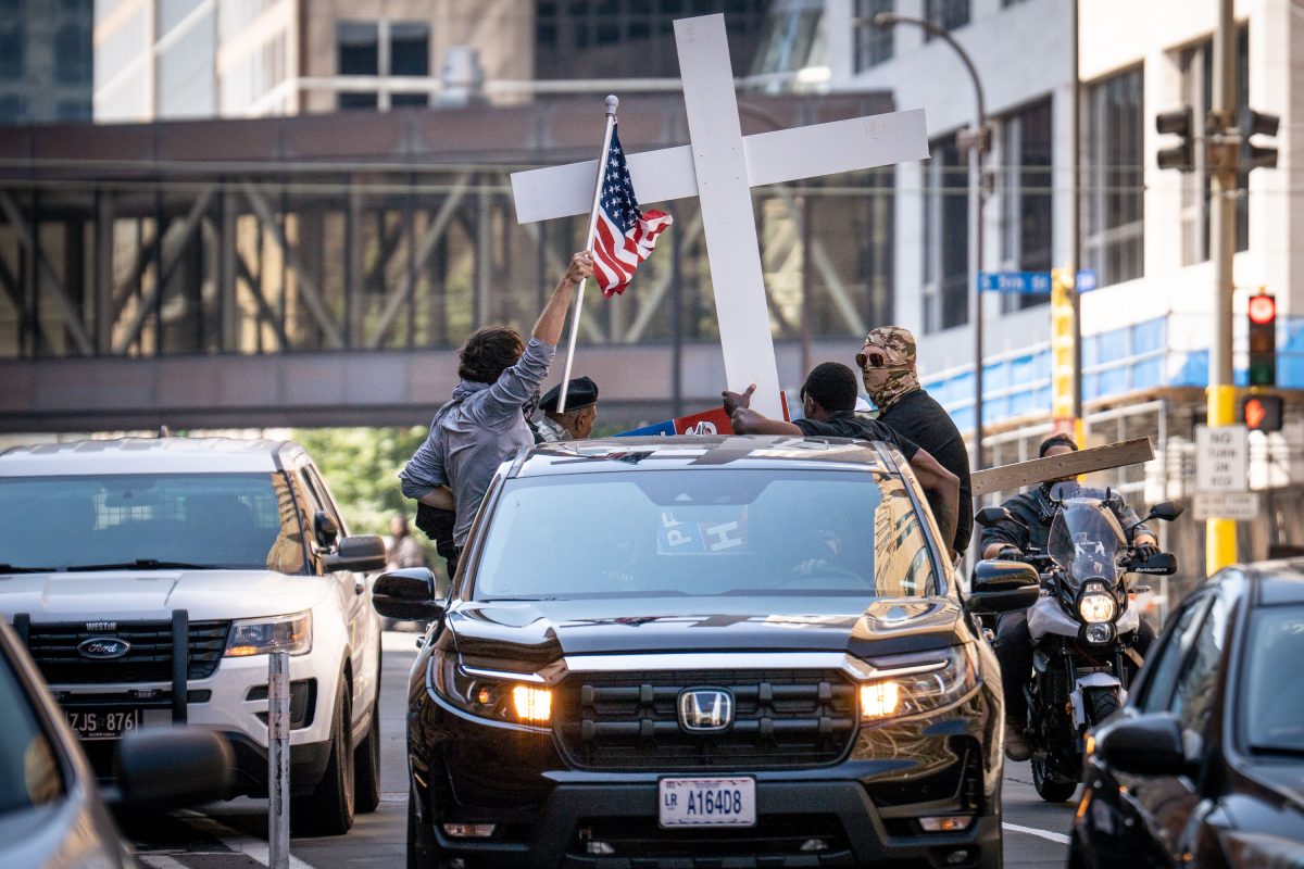 Protesters hold a cross and American flag during a counter-protest in Minneapolis.
