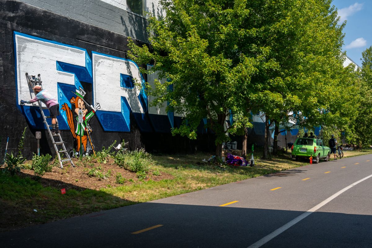 Mural being painted on Midtown Greenway in August 2026