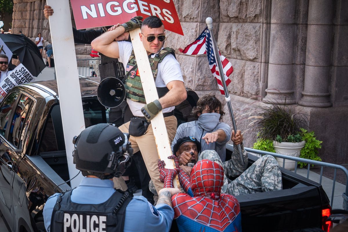 Counter protesters confront a vehicle outside Minneapolis City Hall during a white supremacist rally.