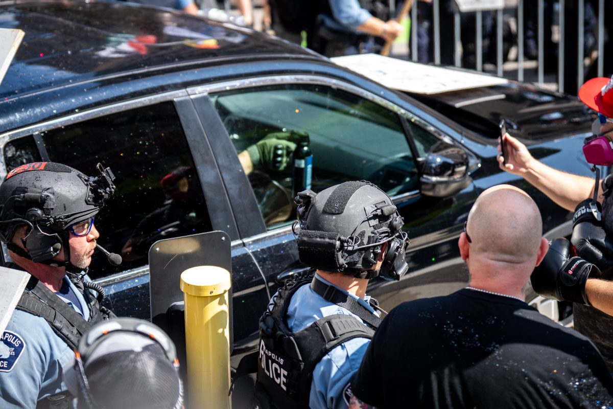 Police and private security officers surround a vehicle during a white supremacist rally confrontation at Minneapolis City Hall.