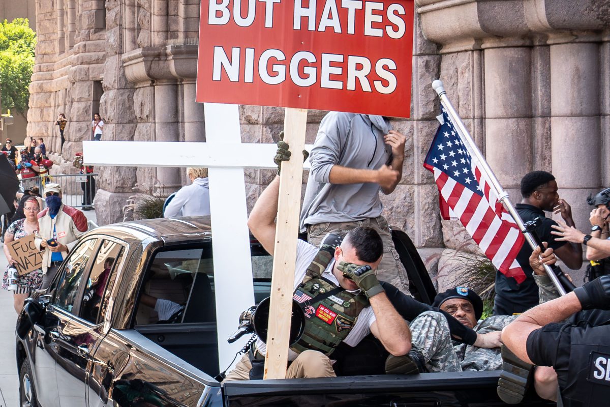 Counter-protesters confront white supremacist Jake Lang's vehicle at Minneapolis City Hall during a rally on August 22, 2026.