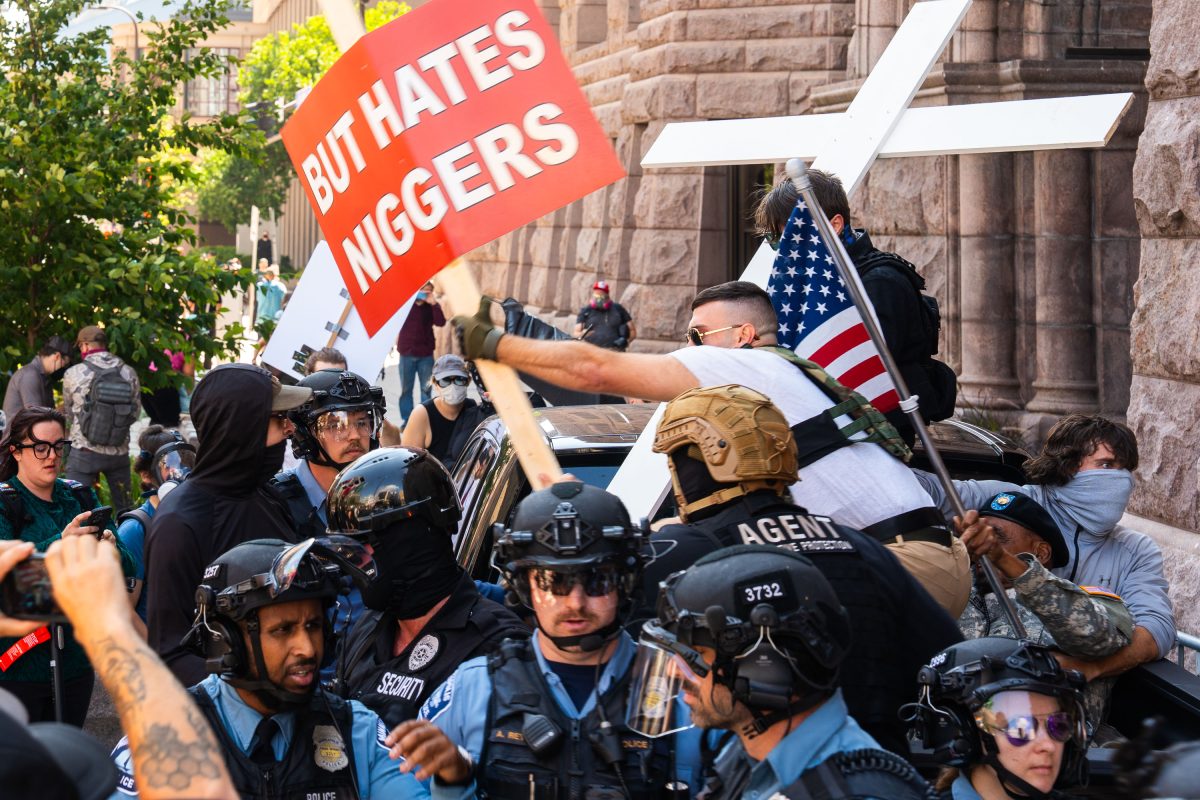 Racist sign clashes with police at Jake Lang rally, Minneapolis City Hall
