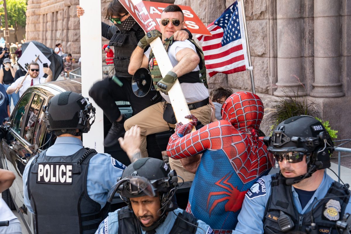 White supremacist Jake Lang and private security personnel confront counter protesters outside Minneapolis City Hall.