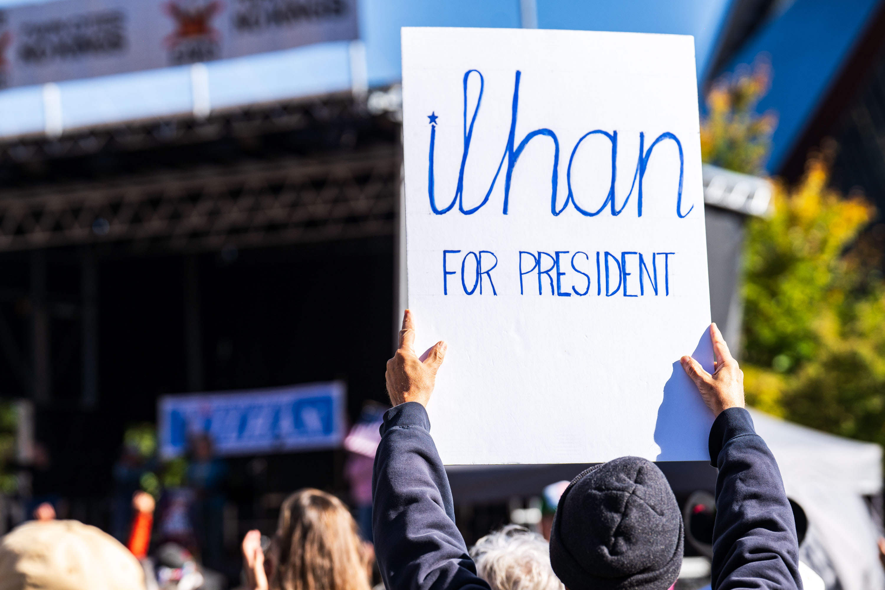 A person holds a handmade sign reading "ilhan FOR PRESIDENT" at the NO KINGS rally in Minneapolis.