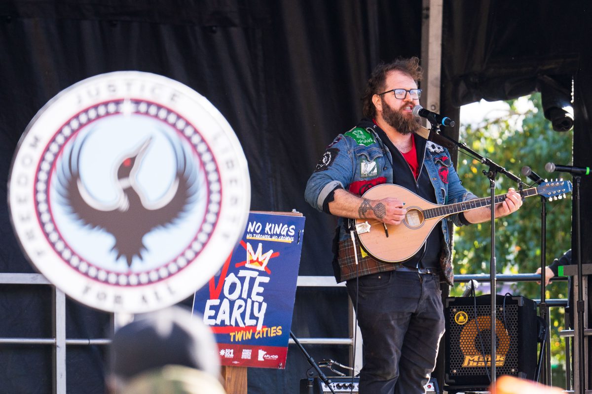 A Minnesota 15 performer at the NO KINGS rally in Minneapolis Commons Park.
