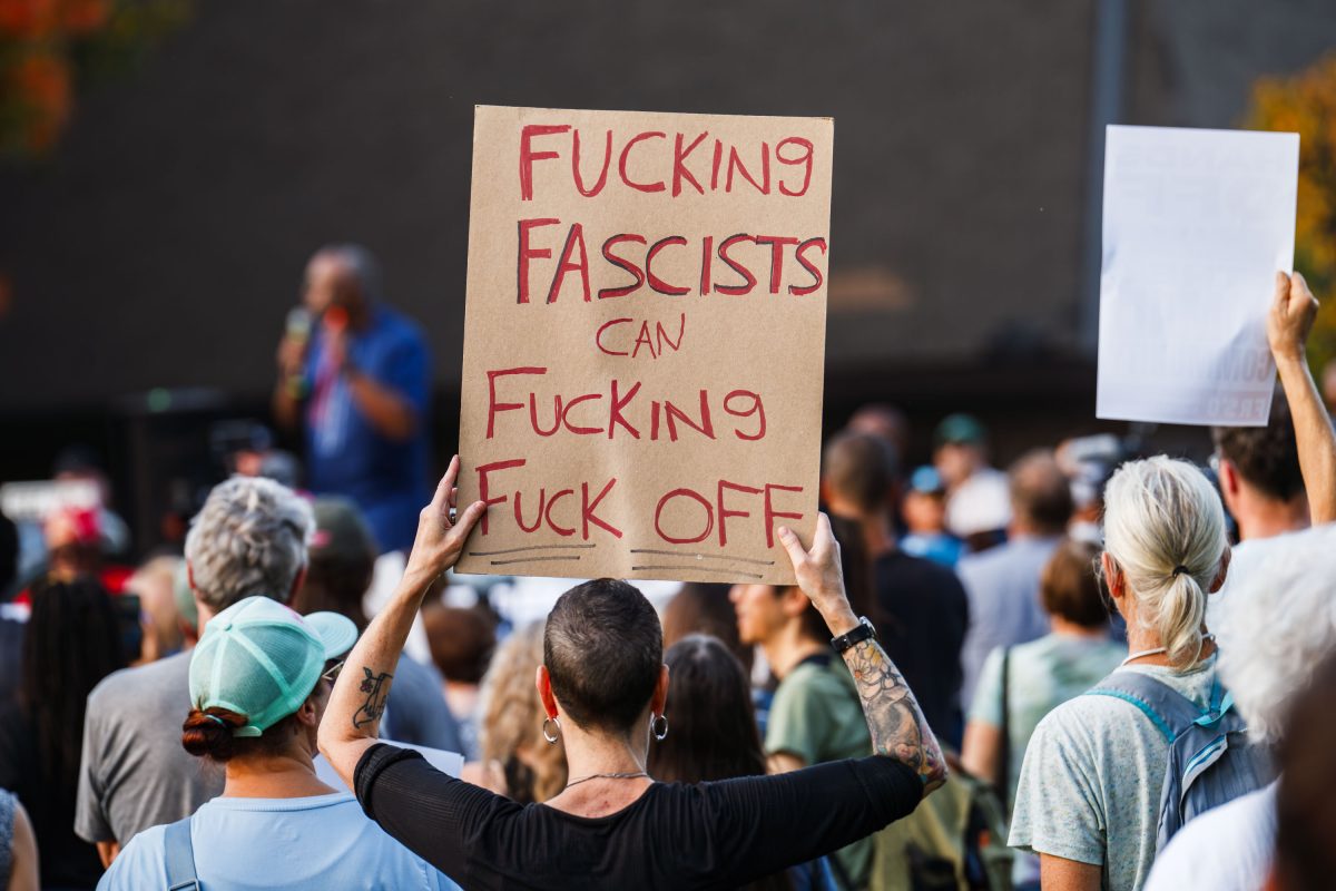 Protester holding a sign at Ilhan Omar rally