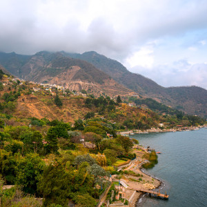 Santa Cruz La Laguna is a traditional Mayan village located on the steep mountainside of the lake, roughly 325 vertical feet above the lake's surface (population: approximately 3,100). The village has the unique characteristic of being accessible only by boat or footpath. A single, winding road connects the dock to the village. There is a very rough road connecting Santa Cruz to Sololá which is used to transport heavy goods, concrete blocks, furniture, and a few vehicles.The village has no roads, telephone system, or commercial center, although a common gathering place in the village is the sports court, used for basketball and soccer by the children of the village. Electricity is intermittent and expensive, and is therefore not installed in many households.Source: https://en.wikipedia.org/wiki/Santa_Cruz_La_Laguna Santa Cruz La Laguna is a traditional Mayan village located on the steep mountainside of the lake, roughly 325 vertical feet above the lake's surface (population: approximately 3,100). The village has the unique characteristic of being accessible only by boat or footpath. A single, winding road connects the dock to the village. There is a very rough road connecting Santa Cruz to Sololá which is used to transport heavy goods, concrete blocks, furniture, and a few vehicles.The village has no roads, telephone system, or commercial center, although a common gathering place in the village is the sports court, used for basketball and soccer by the children of the village. Electricity is intermittent and expensive, and is therefore not installed in many households.Source: https://en.wikipedia.org/wiki/Santa_Cruz_La_Laguna