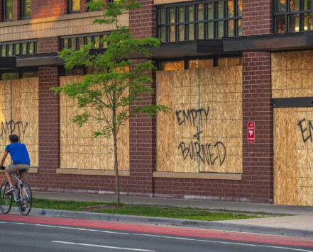 June 6, 2020 - Minneapolis — A cyclist bikes down Hennepin Avenue in Uptown Minneapolis past a boarded up Walgreens Pharmacy. Boards were placed after unrest in Minneapolis over the killing of George Floyd on May 25th, 2020. June 6, 2020 - Minneapolis — A cyclist bikes down Hennepin Avenue in Uptown Minneapolis past a boarded up Walgreens Pharmacy. Boards were placed after unrest in Minneapolis over the killing of George Floyd on May 25th, 2020.
