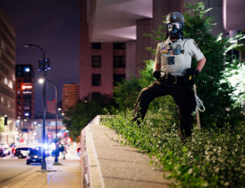 Hennepin County Sheriffs Officer with a gas mask on outside the Hennepin County Jail in downtown Minneapolis.