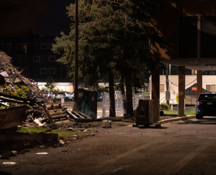 A Minneapolis Police Officer under the burned out Wells Fargo Bank on Nicollet Ave. The bank sits across the street from the Fifth Precinct and was burned during unrest. A Minneapolis Police Officer under the burned out Wells Fargo Bank on Nicollet Ave. The bank sits across the street from the Fifth Precinct and was burned during unrest.