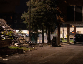 A Minneapolis Police Officer under the burned out Wells Fargo Bank on Nicollet Ave. The bank sits across the street from the Fifth Precinct and was burned during unrest.