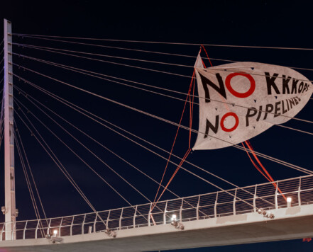 A banner that reads "NO KKKOPS NO PIPELINES" hung over the Martin Olav Sabo Bridge in Minneapolis. A banner that reads "NO KKKOPS NO PIPELINES" hung over the Martin Olav Sabo Bridge in Minneapolis.
