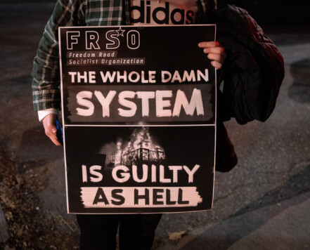 A protester holds a sign before a march in downtown Minneapolis on election night. A protester holds a sign before a march in downtown Minneapolis on election night.