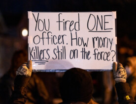 Protesters march down Rice St. a day after police released the body cam footage of a St. Paul police officer shooting a nude unarmed black man who was being attacked by a K9. The officer was fired by the force.