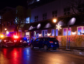 Minneapolis Police parked outside Fire House bar/restaurant in Uptown Minneapolis.Graffiti that reads “No Good cops. No bad protesters”