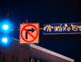 W. Lake St. sign on Hennepin Ave in Uptown Minneapolis. The paint peeling from burning dumpsters during unrest following the law enforcement killing of Winston Smith in June 2021.