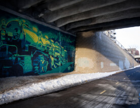 A train mural by Reggie LeFlore on the Midtown Greenway in South Minneapolis.