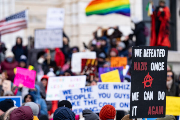 Protester at the Minnesota State Capitol on February 5, 2025 holding up a sign that reads "We defeated nazis once we can do it again". Protester at the Minnesota State Capitol on February 5, 2025 holding up a sign that reads "We defeated nazis once we can do it again".