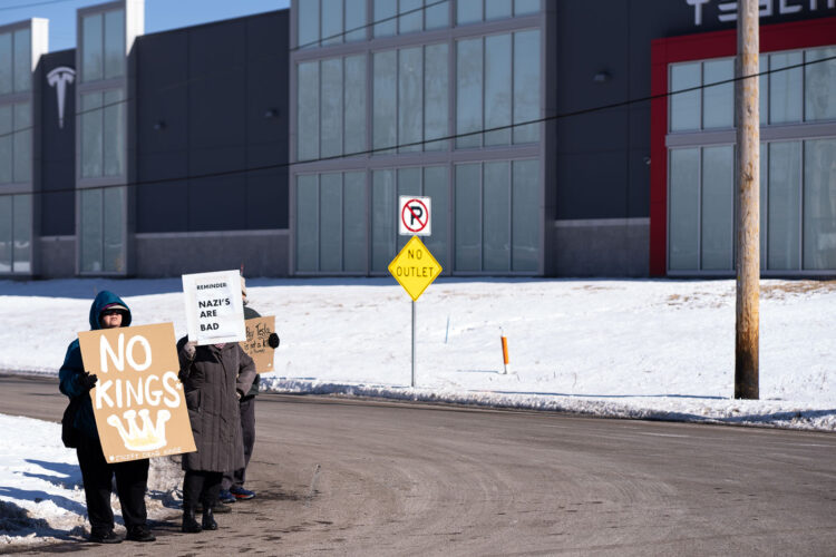 Protesters hold up signs reading "No Kings (Except Drag Kings) "Reminder: Nazi's Are Bad" at a "Tesla Takedown" protest in front of a Tesla facility in Minneapolis on February 22, 2025. Protesters hold up signs reading "No Kings (Except Drag Kings) "Reminder: Nazi's Are Bad" at a "Tesla Takedown" protest in front of a Tesla facility in Minneapolis on February 22, 2025.