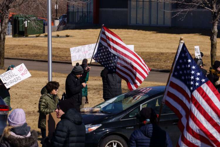 An upside down American Flag and a right side up American Flag seen outside a Tesla facility in Minneapolis (Golden Valley) on March 1, 2025. Protesters have been gathering for weeks now protesting the actions of Elon Musk and his Doge Department under the Trump administration. An upside down American Flag and a right side up American Flag seen outside a Tesla facility in Minneapolis (Golden Valley) on March 1, 2025. Protesters have been gathering for weeks now protesting the actions of Elon Musk and his Doge Department under the Trump administration.