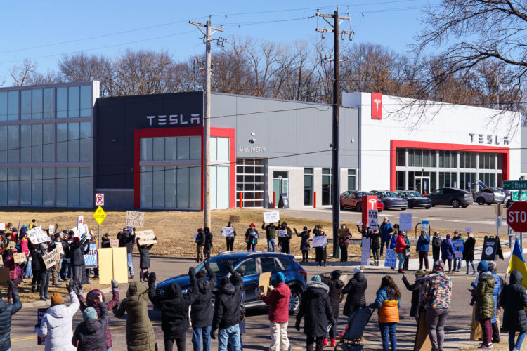 Protesters outside of a Tesla facility in Golden Valley, Minnesota on March 1st, 2025. This is the third weekend in a row they've gathered to protest the actions of Elon Musk and the current administration. Protesters outside of a Tesla facility in Golden Valley, Minnesota on March 1st, 2025. This is the third weekend in a row they've gathered to protest the actions of Elon Musk and the current administration.