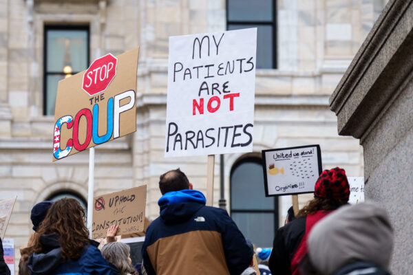 "My patients are not parasites" protest sign in St. Paul Minnesota.Protesters at the Minnesota State Capitol in St. Paul, Minnesota on March 4, 2025.  Taking place on the afternoon of President Trump’s first address to joint session in congress, they are protesting the actions of the Trump Administration and Elon Musk’s involvement. The protest was organized as part of the “50501” protests taking place around the country. This is the first of two planned protests this week. Another is planned for Saturday at the State Capitol. "My patients are not parasites" protest sign in St. Paul Minnesota.Protesters at the Minnesota State Capitol in St. Paul, Minnesota on March 4, 2025.  Taking place on the afternoon of President Trump’s first address to joint session in congress, they are protesting the actions of the Trump Administration and Elon Musk’s involvement. The protest was organized as part of the “50501” protests taking place around the country. This is the first of two planned protests this week. Another is planned for Saturday at the State Capitol.