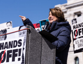 Amy Klobuchar speaking to a crowd of around 25,000 at a "Hands Off!" protest at the Minnesota State Capitol
