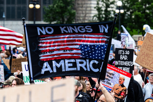 Protester holds up a No Kings in America flag during a June No Kings protest.Despite warnings from the law enforcement not to attend today’s No Kings rally after this mornings shootings of Minnesota lawmakers with the killer on the lose, the No Kings Rally is happening at the Minnesota State Capitol in St. Paul. Protester holds up a No Kings in America flag during a June No Kings protest.Despite warnings from the law enforcement not to attend today’s No Kings rally after this mornings shootings of Minnesota lawmakers with the killer on the lose, the No Kings Rally is happening at the Minnesota State Capitol in St. Paul.