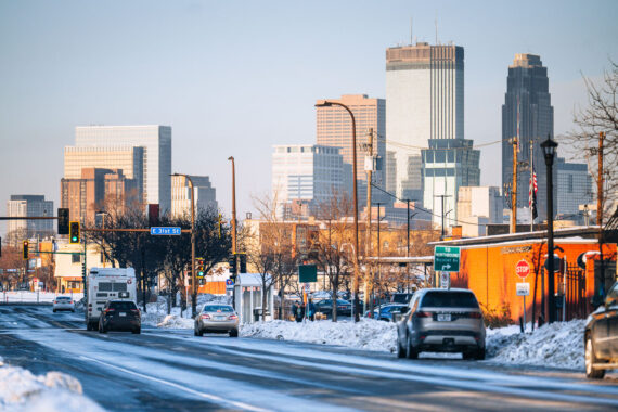 Snow covered Nicollet Ave and the Minneapolis Skyline. The Minneapolis police 5th precinct police station on the right. Snow covered Nicollet Ave and the Minneapolis Skyline. The Minneapolis police 5th precinct police station on the right.